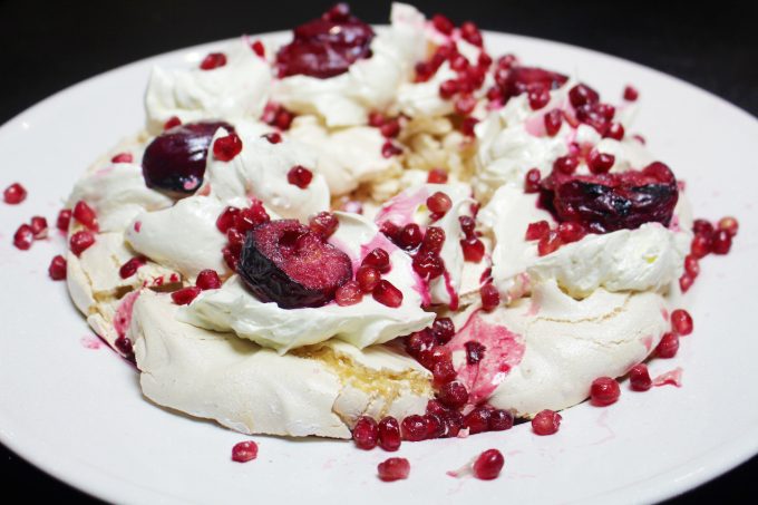 meringue wreath with mulled plums and pomegranates 